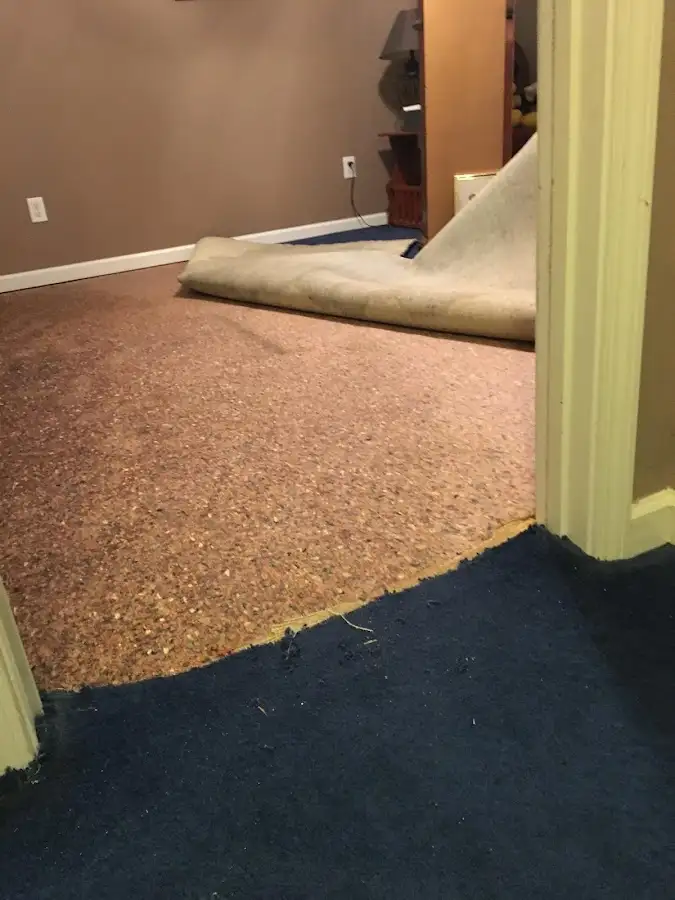 Carpet pad removal revealing water damage during Water Mitigation Services in Chino Hills
